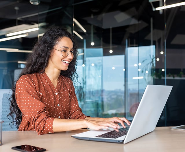 female attending the Leaders Annual Meeting on laptop